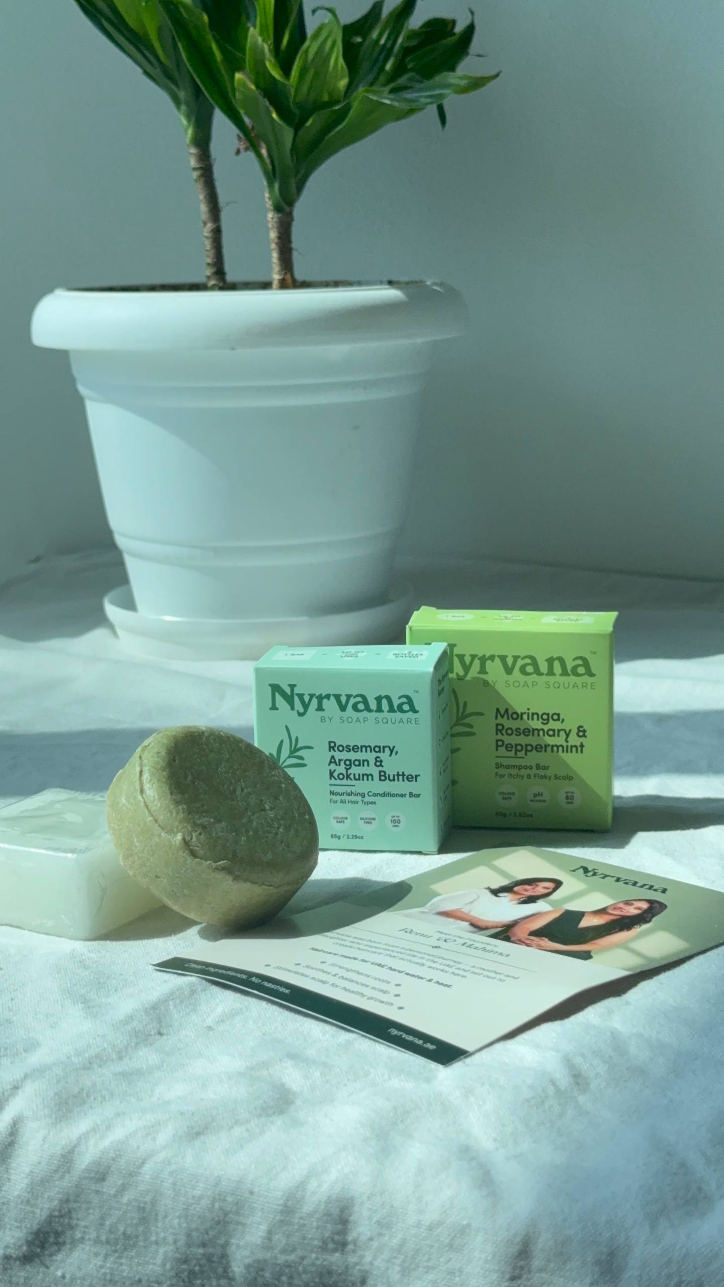 Close-up of Nyrvana solid shampoo and conditioner bars